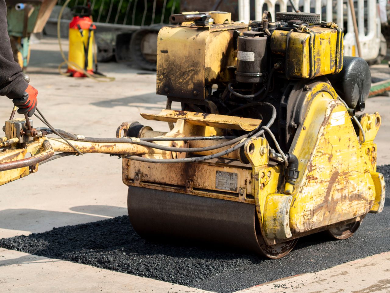 contact-img Close-up of a road roller in action during asphalt repair in Wrocław, Poland.